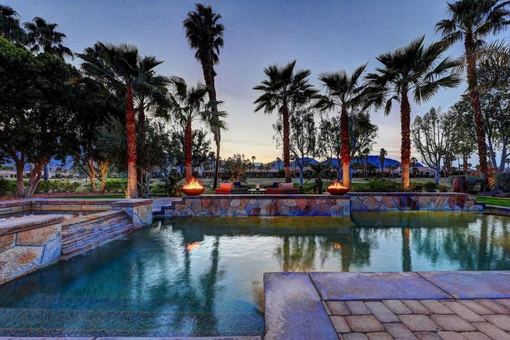 a swimming pool with palm trees in a park at Escape to Legends - Pool, Games & Amazing Mountain Views in PGA West #067651 5br in La Quinta
