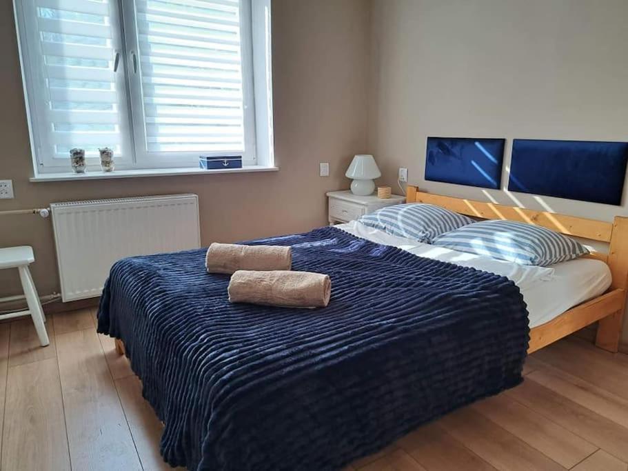Posteľ alebo postele v izbe v ubytovaní Apartamenty i Pokoje Piaskowy Mak