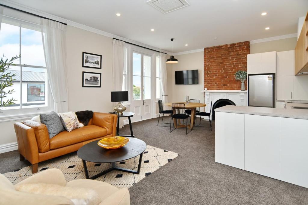 a kitchen and living room with a couch and a table at Kaiapoi Luxury Accommodation 1 - Bookahome in Kaiapoi