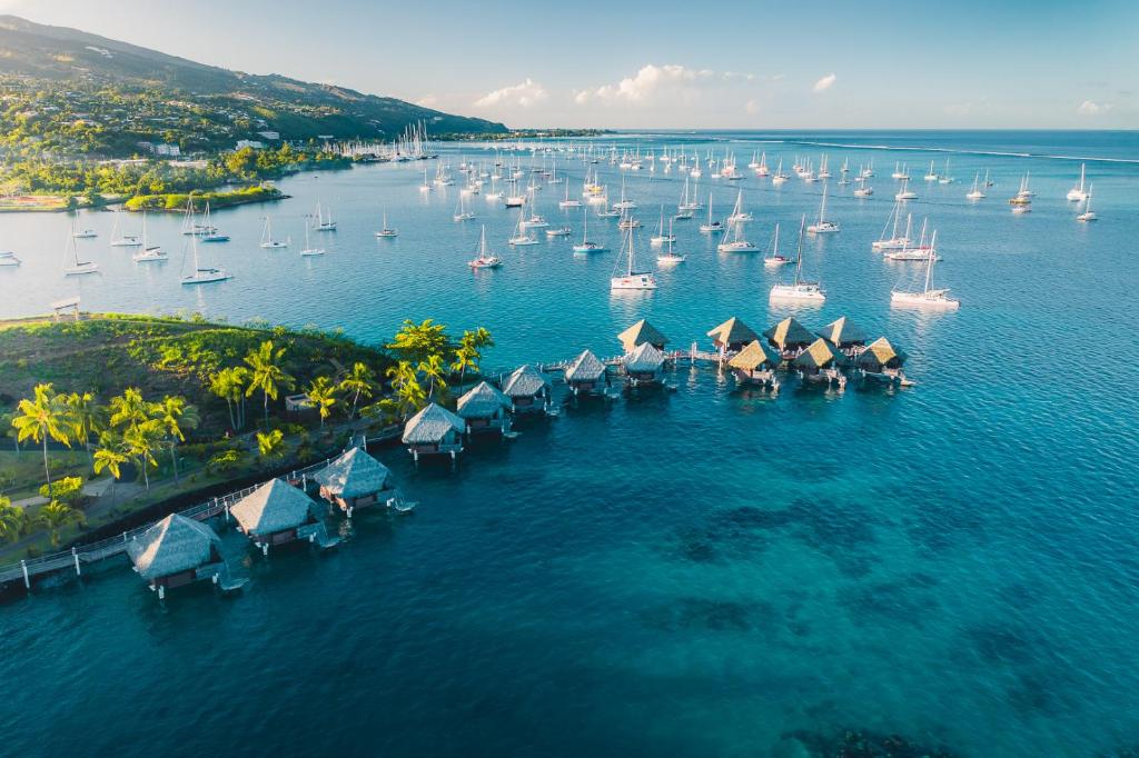 an aerial view of a harbor with boats and sailboats at InterContinental Tahiti Resort & Spa, an IHG Hotel in Faaa