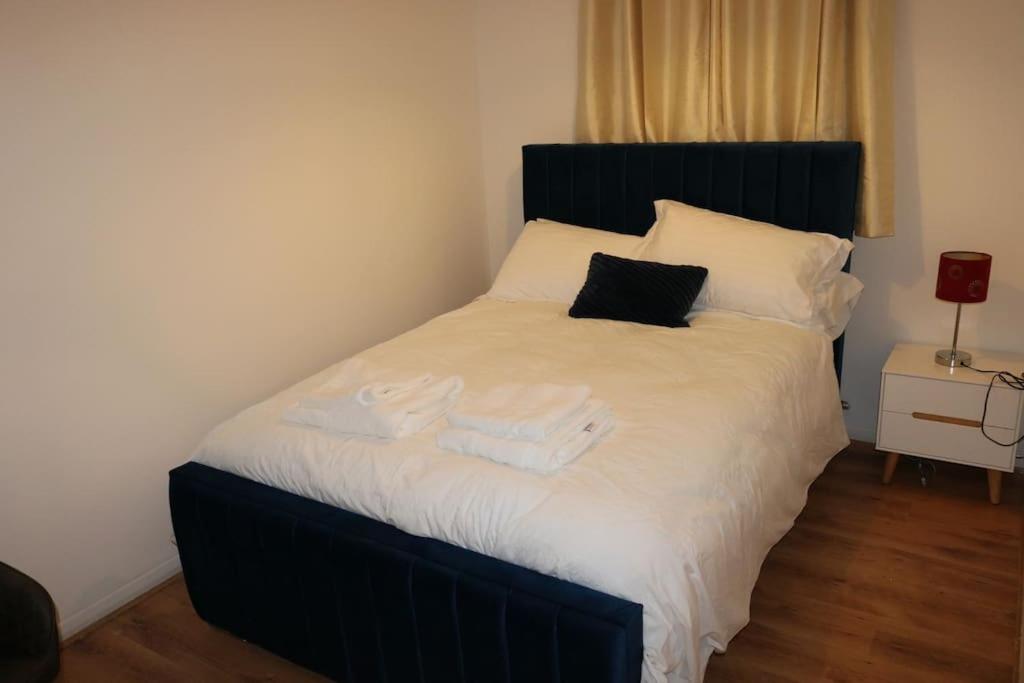 a bedroom with a bed with towels on it at Entire -4 Bedrooms Detached House with Driveway in Nottingham