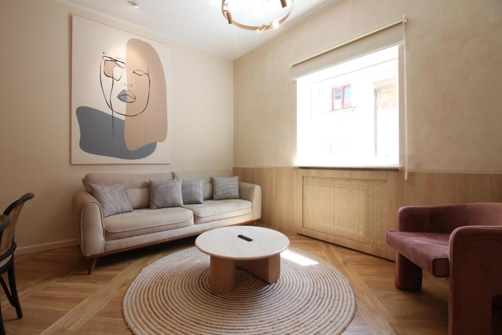 a living room with a couch and a table at Beige Apartment in Sarajevo