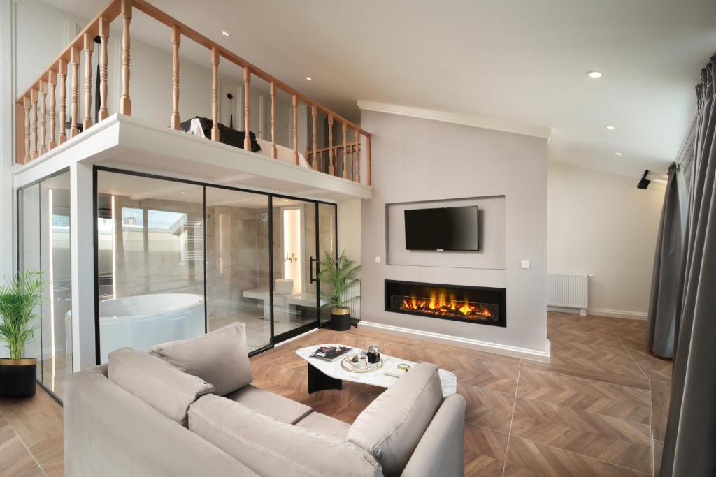 a living room with a couch and a fireplace at Gatto Suites&Residence in Istanbul