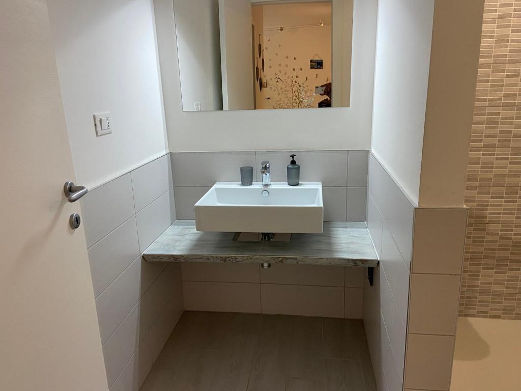 a bathroom with a sink and a mirror at Bari Lory’s Home in Bari