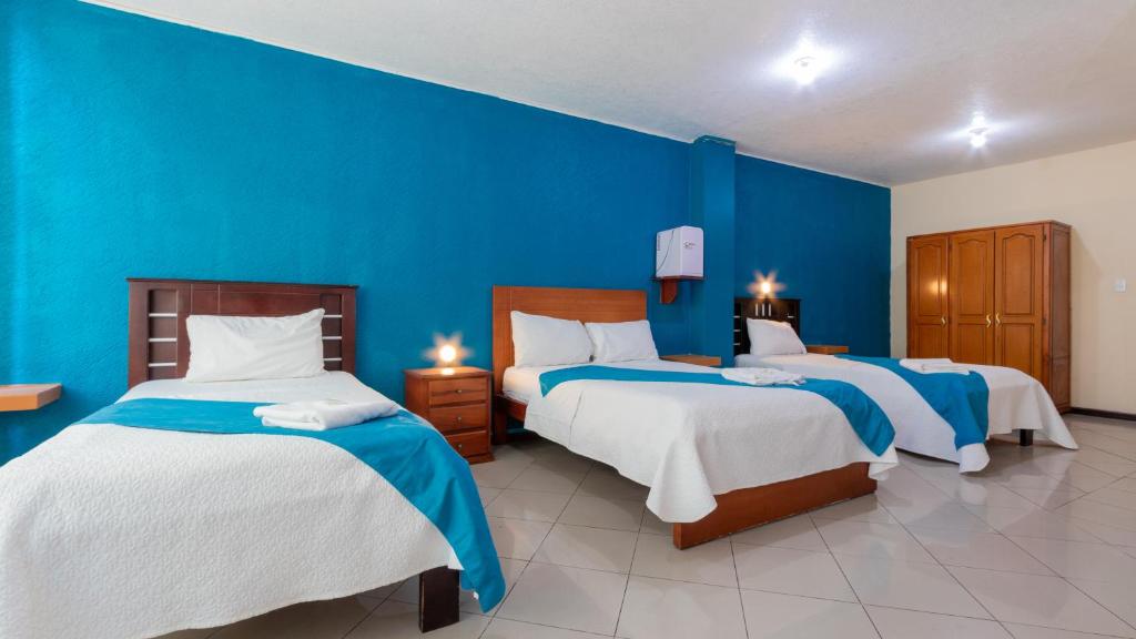 Postel nebo postele na pokoji v ubytování Hotel Miraflores