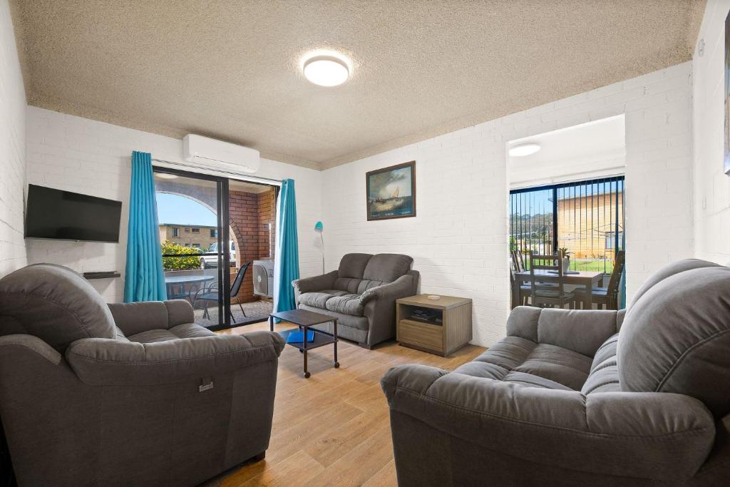 a living room with two couches and a television at Apollo Unit 17 Ground Floor in Narooma