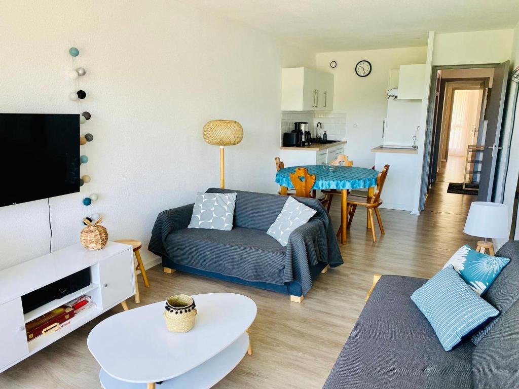 a living room with a couch and a table at Appartement Villard-de-Lans, 3 pièces, 6 personnes - FR-1-689-21 in Villard-de-Lans