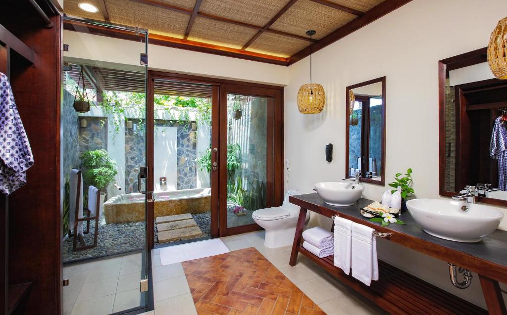 a bathroom with two sinks and a shower at Pandanus Resort in Mui Ne