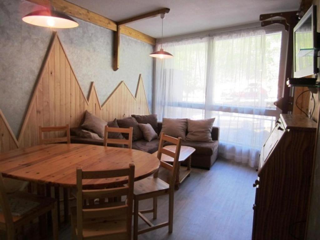 a living room with a table and a couch at Appartement Villard-de-Lans, 2 pièces, 7 personnes - FR-1-689-56 in Villard-de-Lans