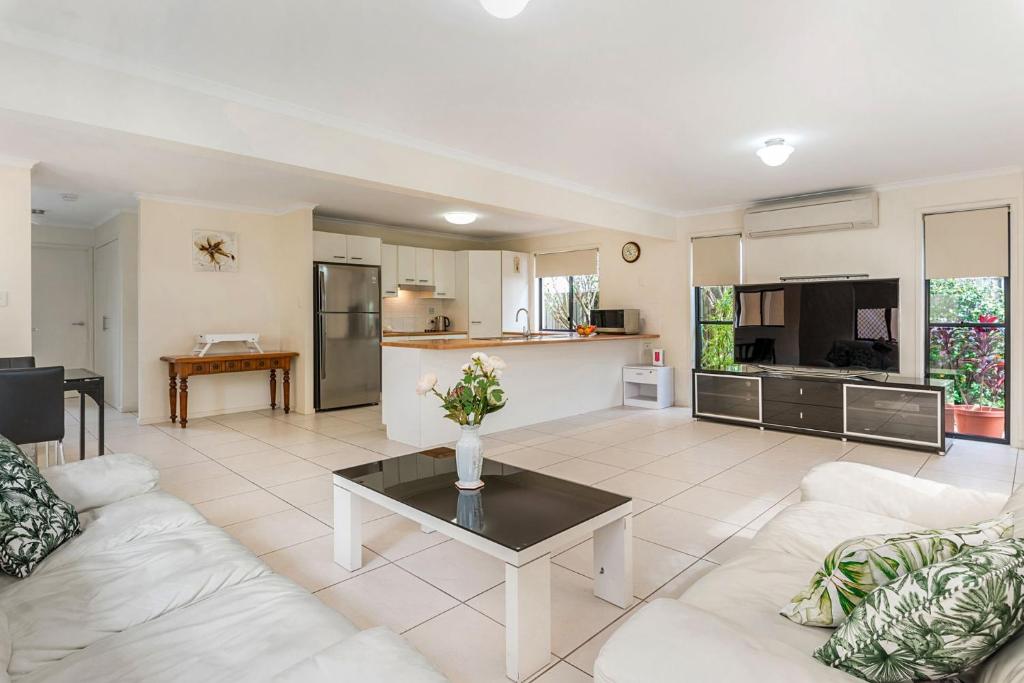 a living room with a couch and a table at Bluefin in Noosaville