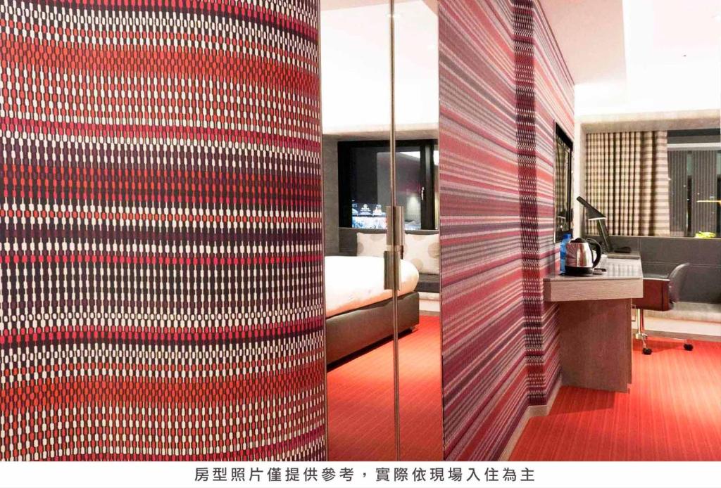 a room with a red and white wall at Royal Hotel Group- Central Park Branch in Kaohsiung