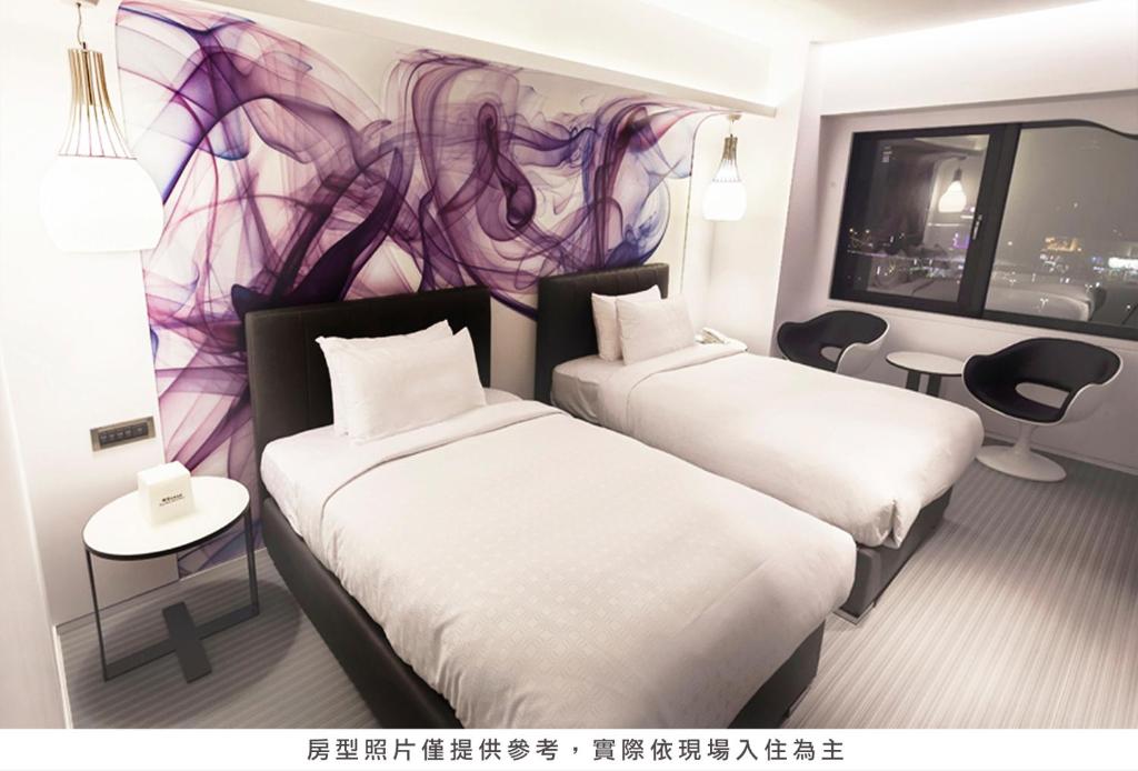 a hotel room with two beds and a mural at Royal Hotel Group- Central Park Branch in Kaohsiung