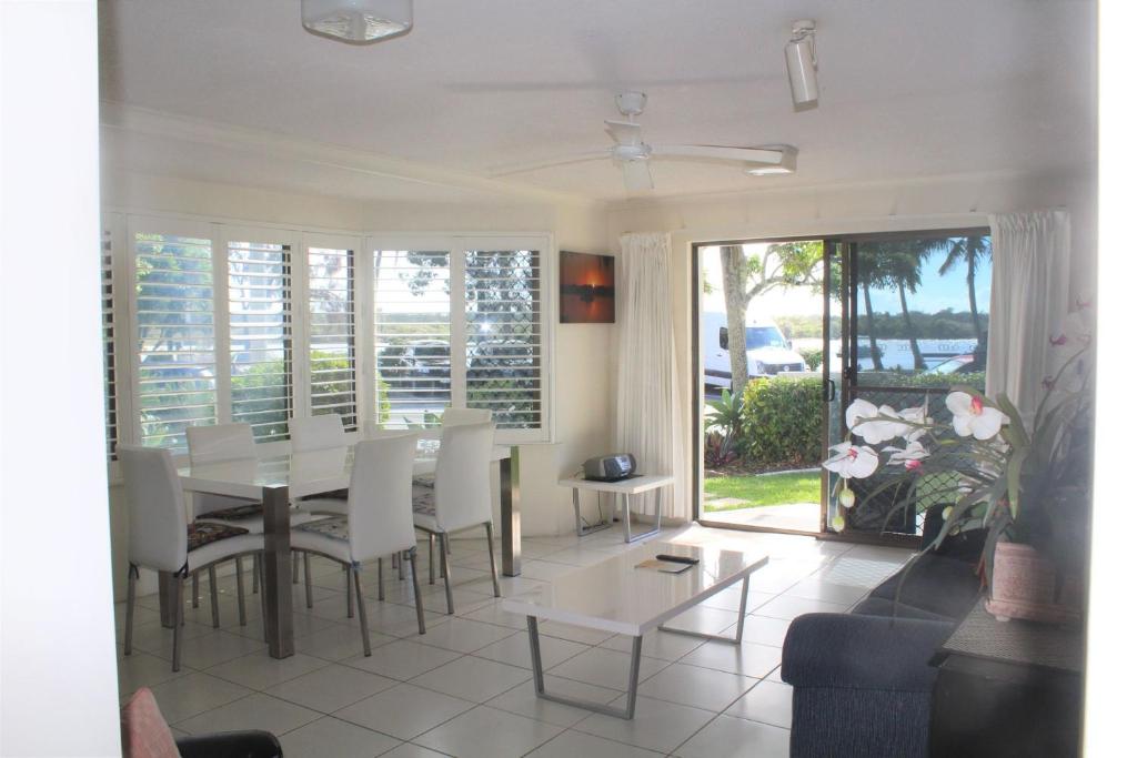 a living room with a table and a couch at 1 Aarons Villa in Noosaville