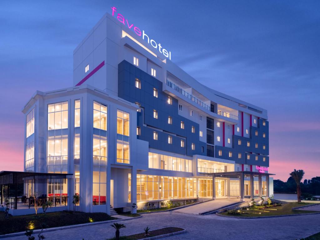 a large building with a hotel sign on it at favehotel Kediri in Kediri