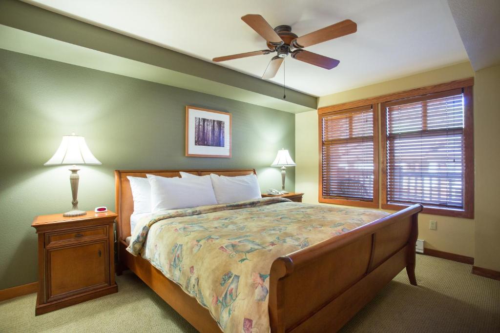 a bedroom with a bed and a ceiling fan at 1205B - Double Queen Standard Eagle Springs West condo in Solitude