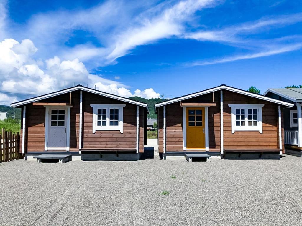 a row of wooden huts in a parking lot at the room 