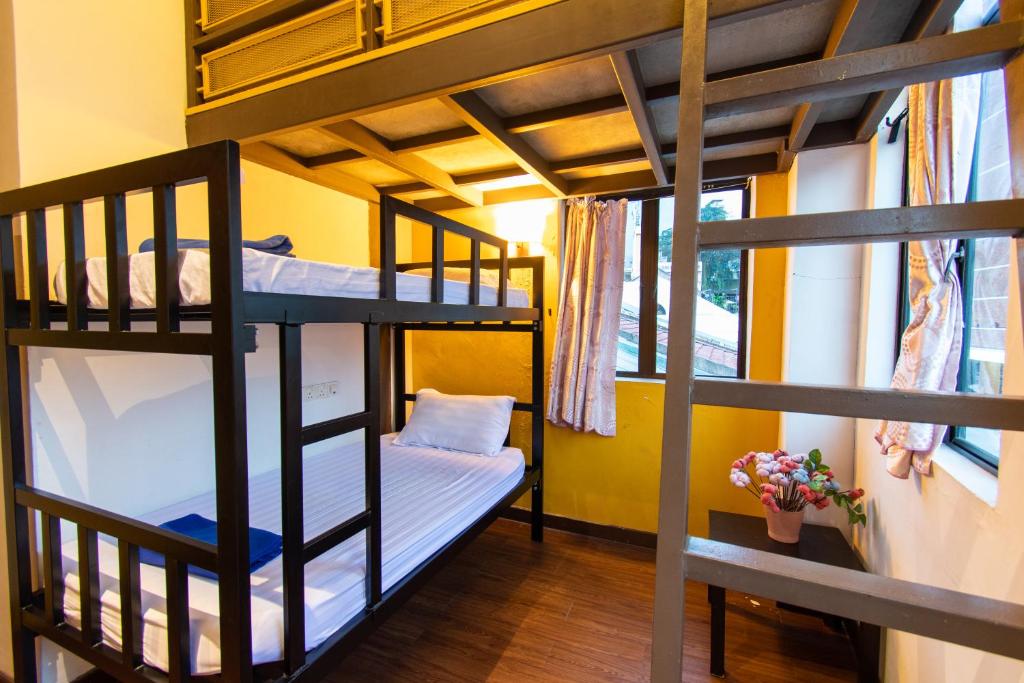 a room with bunk beds in a hostel at Travel Hub Highstreet in Kuala Lumpur