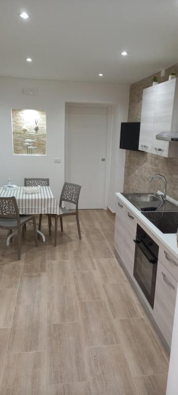 a kitchen with a table and chairs in a kitchen at Come nelle favole home in Bari