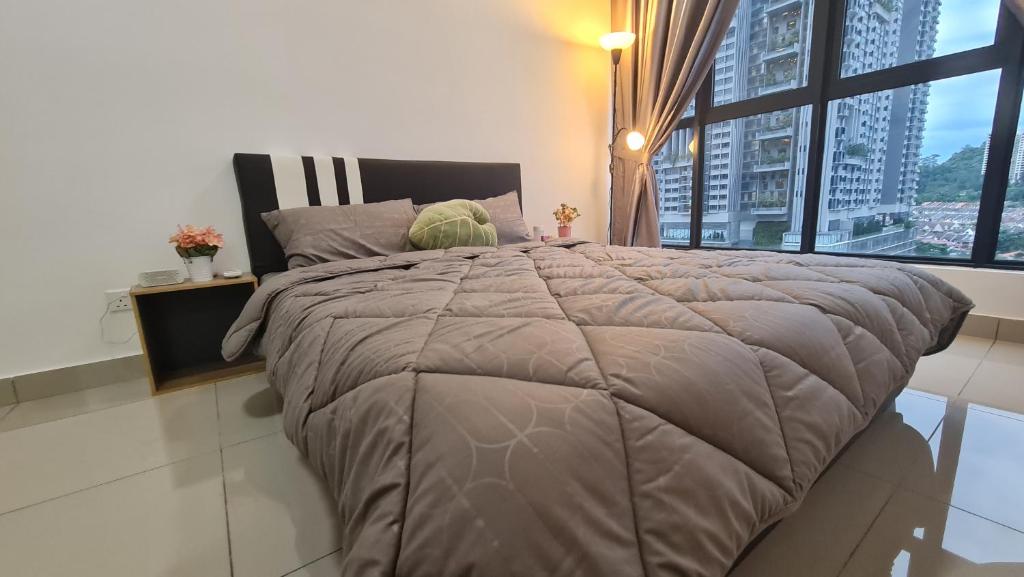 a large bed in a bedroom with a large window at Luxury 5STAR 2Room Resort Suite Mid Valley Sunway Kuala Lumpur by Stayz Suites in Kuala Lumpur
