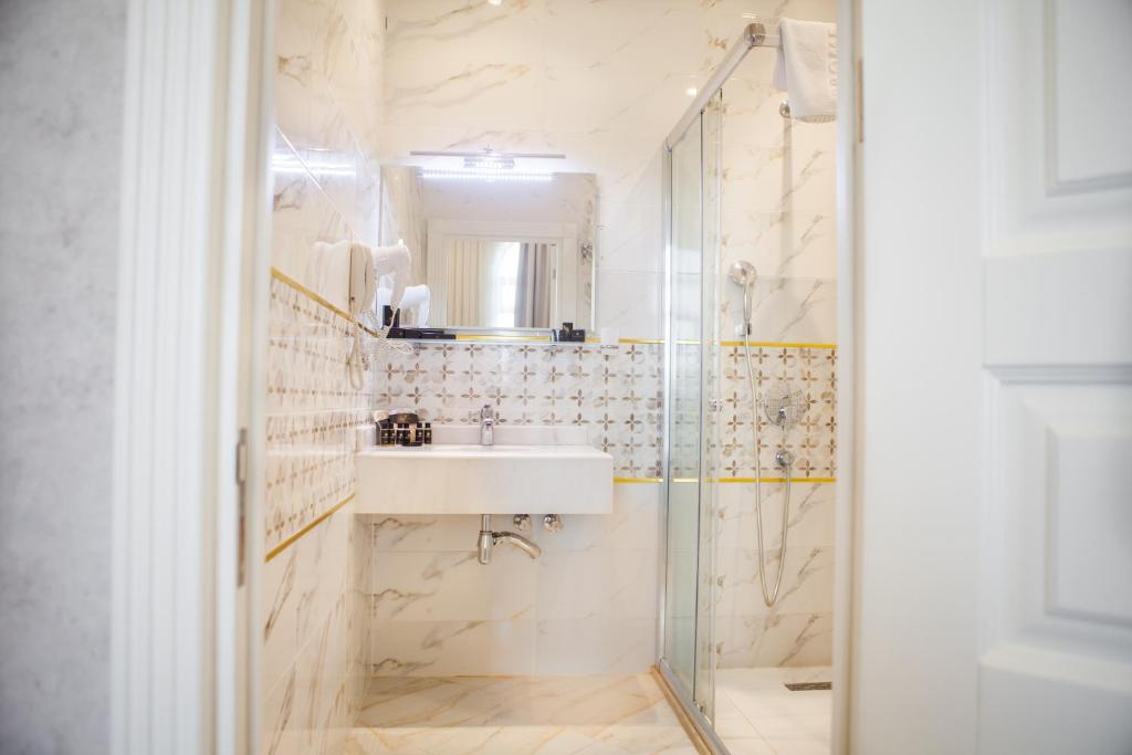 a bathroom with a sink and a shower at Promenade Hotel Baku in Baku