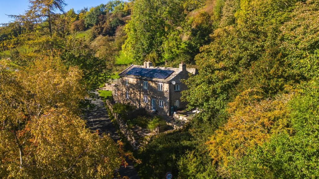 an aerial view of a house in a forest at Peep-O-Day-Stylish 4bedroom cottage with Dale view in Feetham