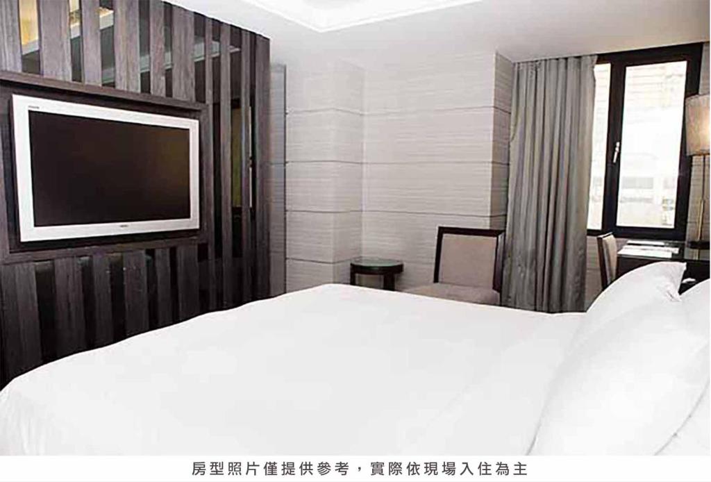 Postel nebo postele na pokoji v ubytování Royal Group Hotel Chun Shan Branch