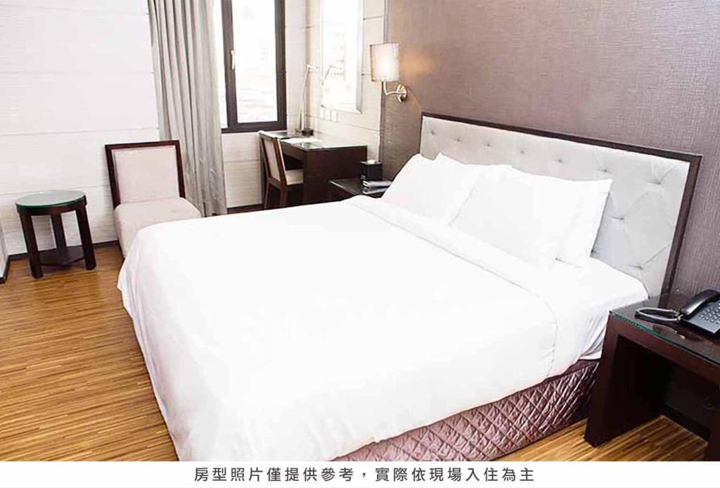 Postel nebo postele na pokoji v ubytování Royal Group Hotel Chun Shan Branch