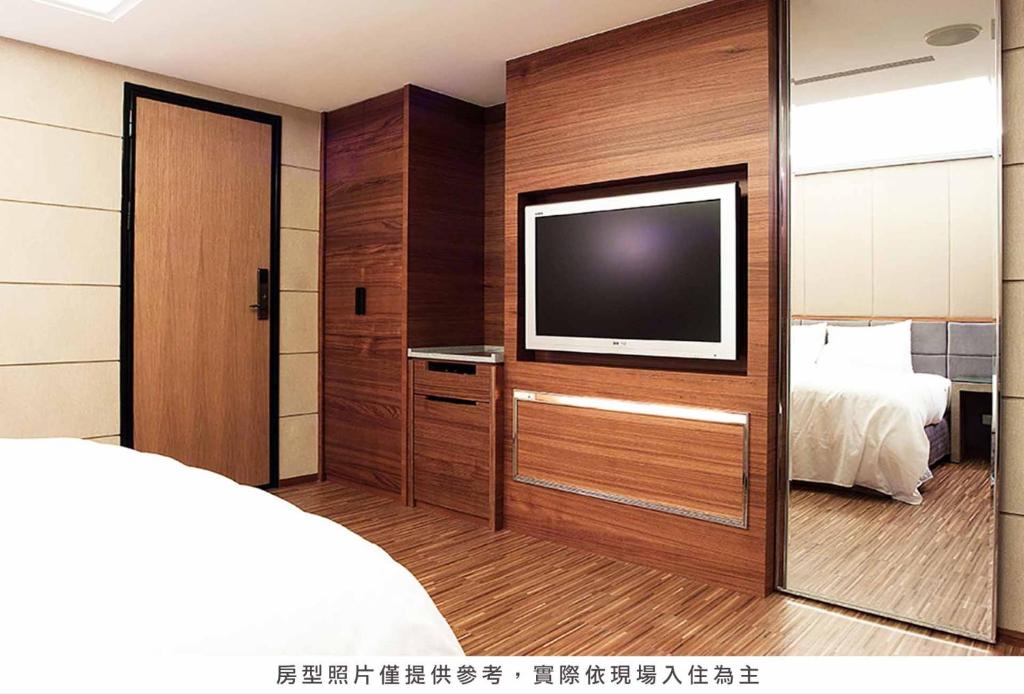 Postel nebo postele na pokoji v ubytování Royal Group Hotel Chun Shan Branch