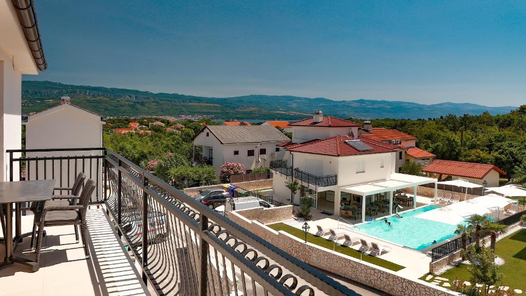 arial view of a villa with a pool and a resort at Cool Šilo Appartement Resort in Šilo