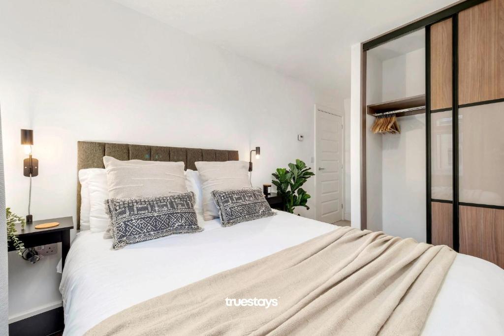 a bedroom with a large white bed with pillows at NEW Berkley House by Truestays - 3 Bedroom House in Stoke-on-Trent in Etruria