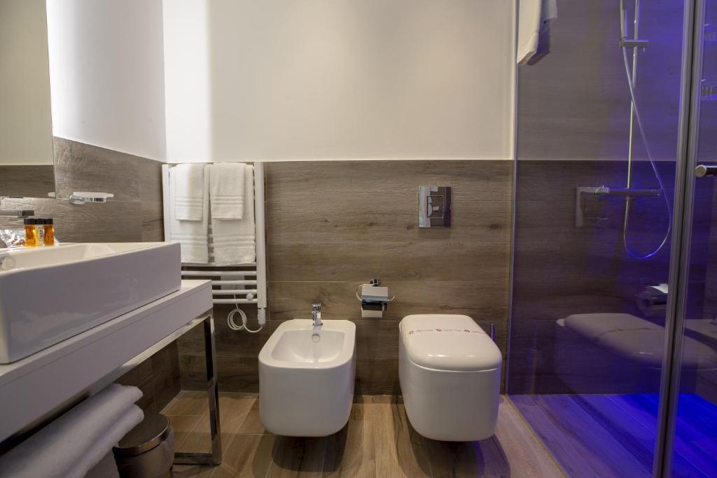 a bathroom with a toilet and a sink at Luxmarì Hotel & Spa in Castellammare del Golfo