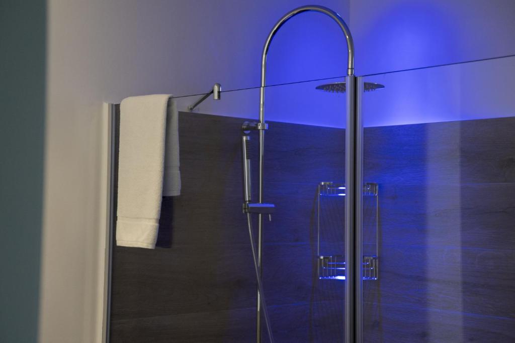 a bathroom with a shower with a glass door at Luxmarì Hotel & Spa in Castellammare del Golfo