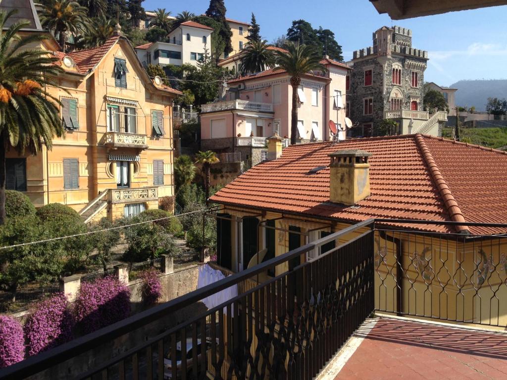 a woman walking on a balcony looking at houses at Elisa Appartamento con parcheggio in Levanto