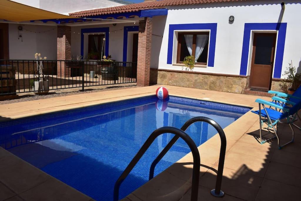 a swimming pool in front of a house at Vivienda con piscina, gimnasio y cocina campera in Villanueva de los Infantes