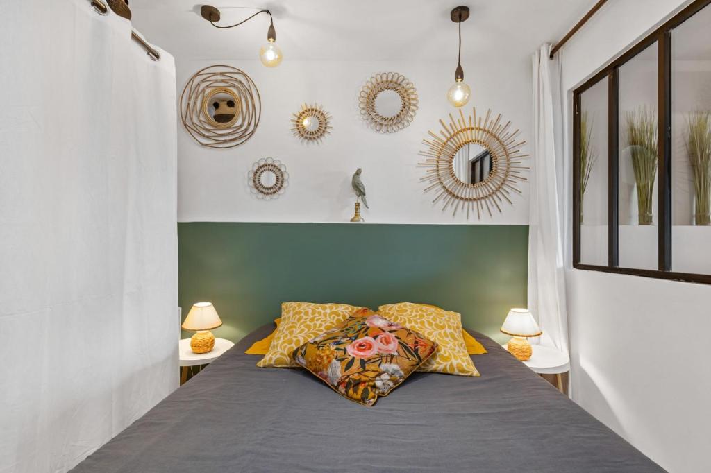 una camera con un letto con due lampade e specchi di Cap d'Agde Studio - Port a Cap d'Agde