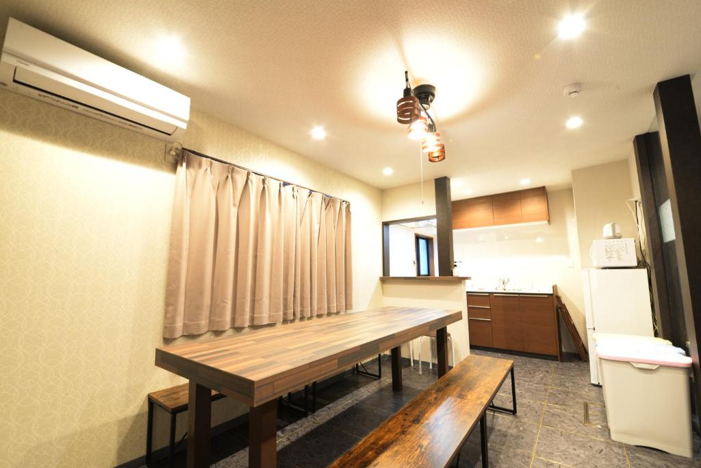 een keuken met een houten tafel in een kamer bij NY Cottage A in Tokyo