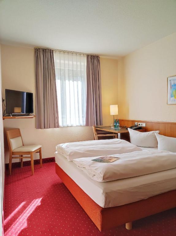 Postel nebo postele na pokoji v ubytování ACHAT Hotel Chemnitz