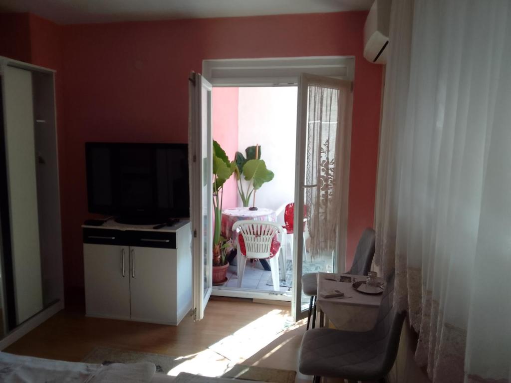 sala de estar con paredes rojas y TV en Biba en Mostar