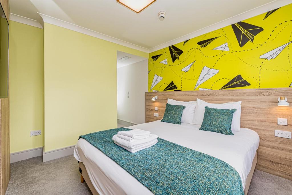 a bedroom with a bed with a painting on the wall at Forty Four Main Street in Swords