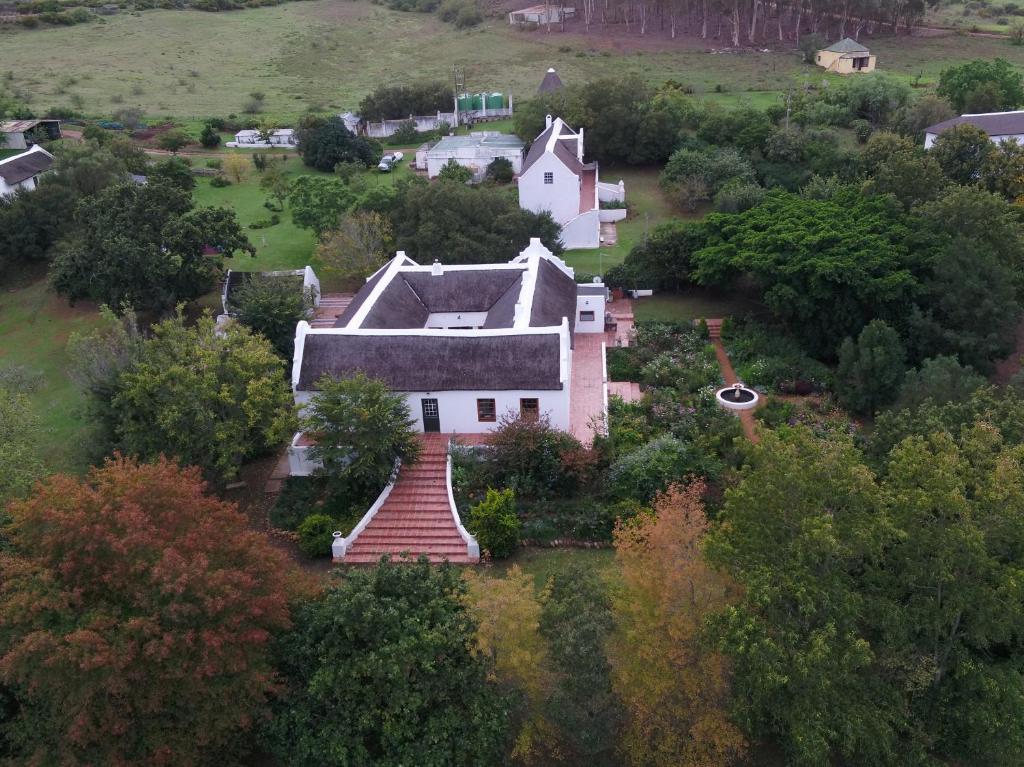 an aerial view of a large white house with a staircase at Zeekoegat Historical Homestead in Riversdale