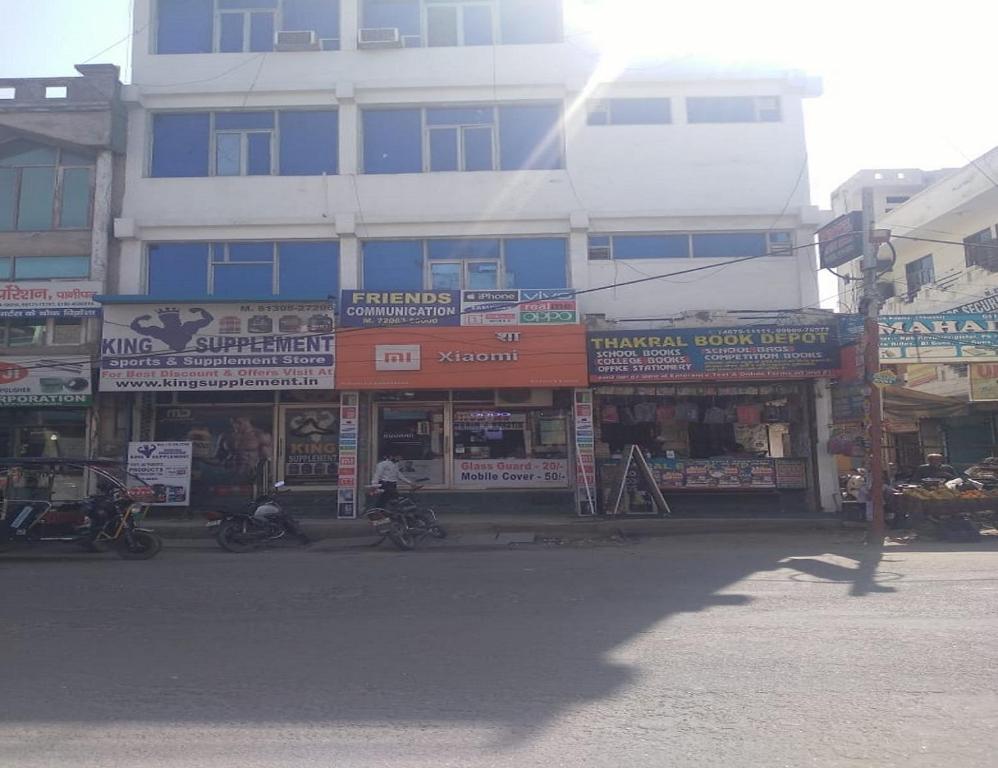 a building with many signs on the side of a street at Hotel Moon Star, Panipat in Pānīpat
