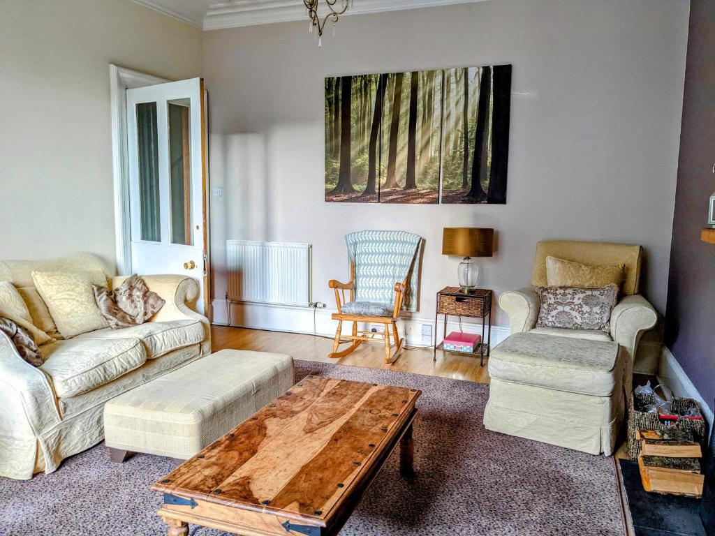 a living room with two couches and a coffee table at Huge 4 Bed Apt - Perfect Base to Explore The Borders in Jedburgh