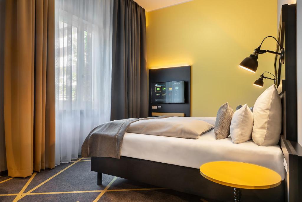 Postel nebo postele na pokoji v ubytování Holiday Inn - the niu, Fury Aschheim Messe by IHG
