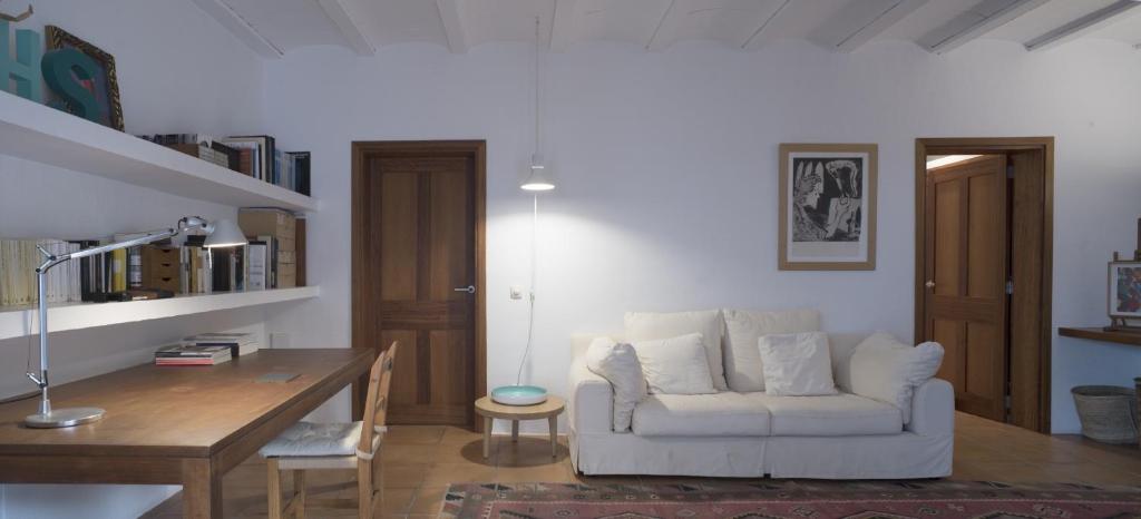 a living room with a white couch and a table at White House Ibiza Modernist Design Can Perez Sea Views Es Figueral in Santa Eularia des Riu