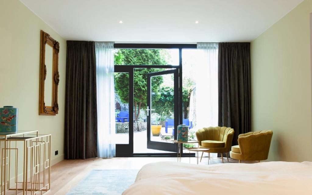 Een bed of bedden in een kamer bij Boutique Hotel De Salon