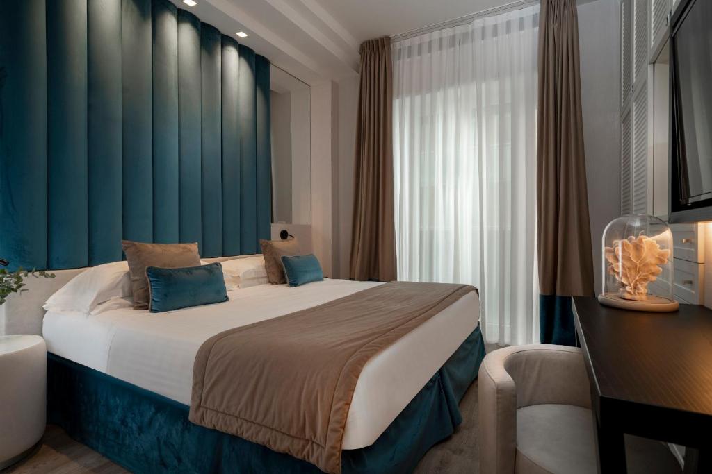 Postel nebo postele na pokoji v ubytování Hotel Lungomare