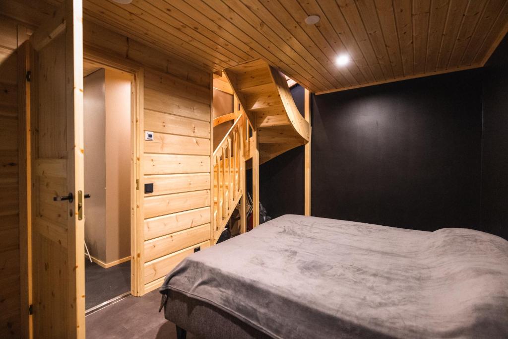 a bedroom with a bunk bed and a staircase at Black Work Levi Aihki in Kittilä