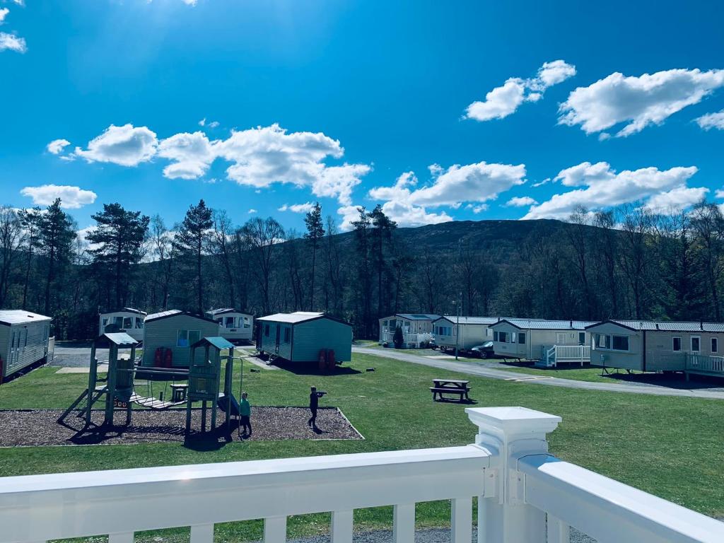 a view of a park with houses and a playground at Tummel valley holiday park in Tummel Bridge