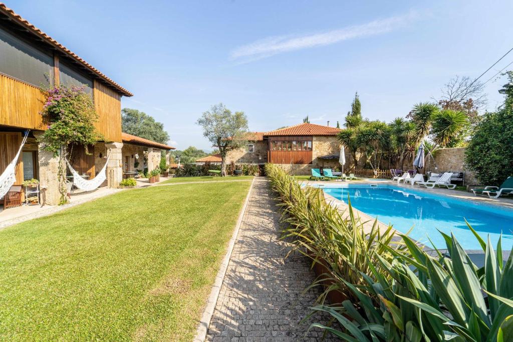an image of a yard with a swimming pool at Casas Casal Do Carvalhal - Agroturismo in Amares