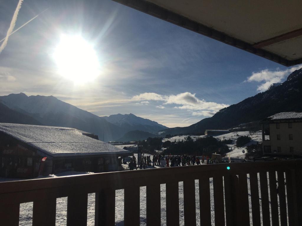 een balkon met uitzicht op een stad met zon bij Le PanoramAS - Front de neige & Balcon ensoleillé - Appartement 2 pièces 4-6 personnes in Termignon